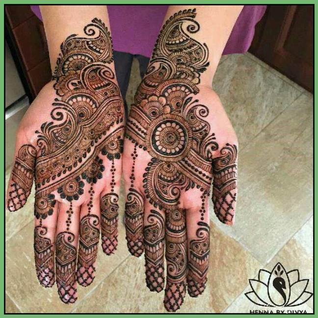 both hands beautiful rangoli